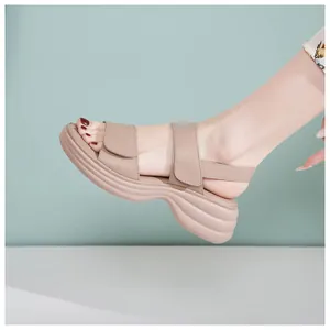 Side view of beige platform sandals with adjustable straps on a model's foot