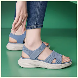 Detail of blue knit platform sandals with breathable mesh and velcro straps on model