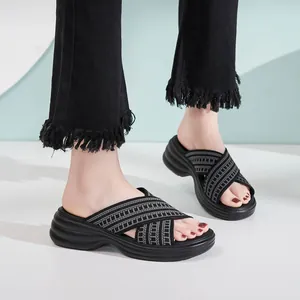 Women's black wedge sandals with woven cross bands and chunky wave sole platform