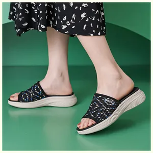 Detail of wedge platform sandals with black knit upper and colorful polka dots pattern