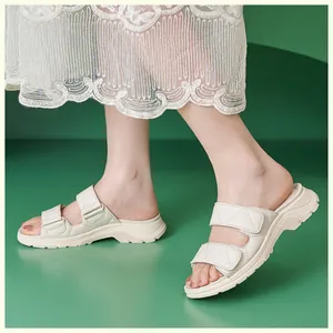 Detalle de sandalias beige acolchadas con doble tira y velcro sobre suela de plataforma