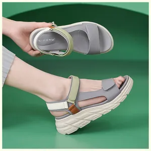 Detail showing the gray and olive green platform sandals with hook and loop straps