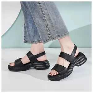 Close-up of women black platform sandals featuring dual straps and adjustable velcro closure