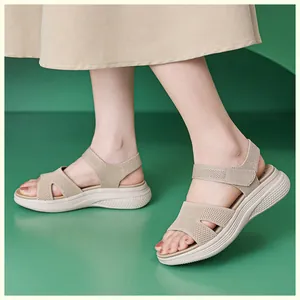 Detail shot of beige platform sandals with knit fabric and velcro ankle strap