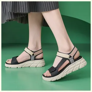 Close-up of lightweight platform sandals with color-block velcro straps on a model
