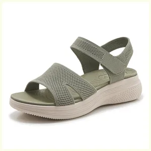 Detail of olive green knit sandal with platform sole and adjustable velcro heel strap
