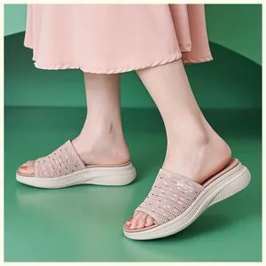 Close-up of pink woven breathable hollow fabric on a platform wedge sandal for women