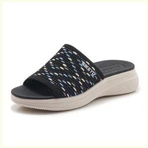 Detail of knitted textured upper and thick anti-slip wedge sole on casual slide sandals
