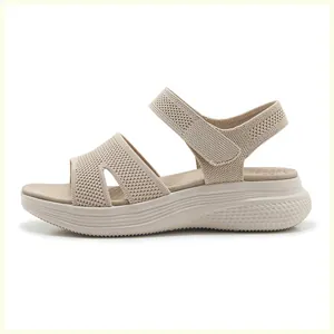 Detail of breathable knit mesh upper and adjustable velcro strap on summer wedge sandals