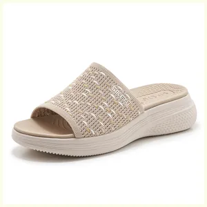 Close-up of beige knitted breathable strap and non-slip platform sole on casual wedge sandals