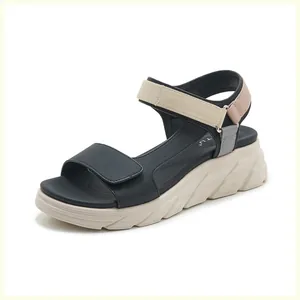 Detail of platform sandals with black velcro straps and colorful patchwork ankle bands
