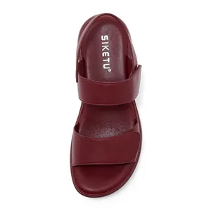 Close-up of wine red platform sandals featuring velcro straps and breathable footbed detail