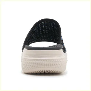 Detail view of the thick non-slip sole and black knit texture of the athletic slide sandal