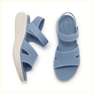 Detail of blue knitted velcro sandals featuring a thick off-white non-slip platform sole