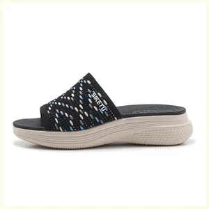 Detail of knitted upper pattern and thick non-slip sole on casual sports slippers
