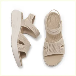 Detail view of beige platform wedge sandals with breathable knit texture and velcro straps