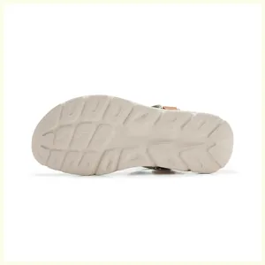 Detailed view of the anti-slip geometric texture on the lightweight off-white sandal sole