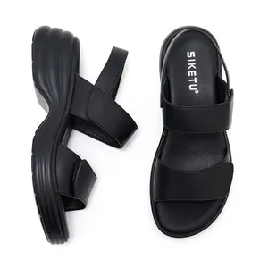 Detail of black platform sandals with velcro straps and anti-slip thick wedge soles