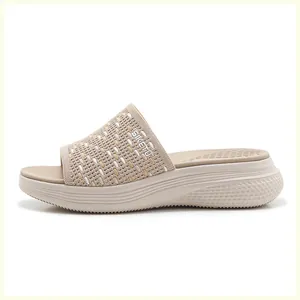 Detail of beige platform sandal featuring breathable knit fabric and ergonomic MD sole