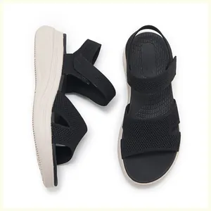 Detail of black knit platform sandals with velcro straps and non-slip wavy sole