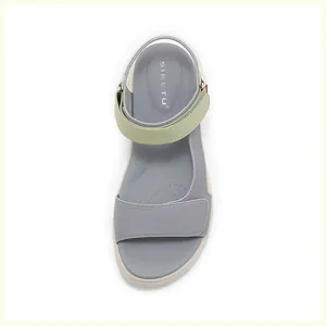 Detailed top view of platform sandals featuring gray and green leather straps and footbed