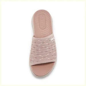 Close-up of pink knitted platform slide with non-slip texture and brand logo