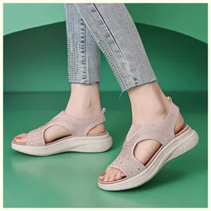 Close-up of nude pink wedge sandals featuring knit fabric and sparkling rhinestones