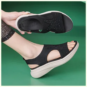 Detail of wedge sandals with black elastic knit fabric and sparkling silver rhinestones
