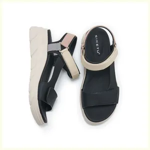 Close-up of contrast color straps and textured non-slip insole on platform sandals