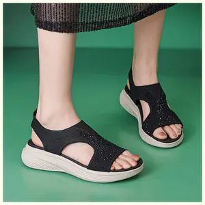 Detail of black knit wedge sandals with rhinestones on a platform sole for women