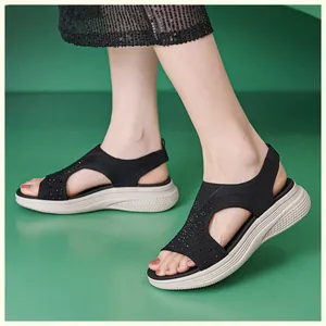 Detail of wedge sandals with black knit upper and sparkling rhinestone embellishments