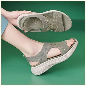 Detail of green knitted platform sandals with rhinestone embellishments and wedge soles