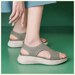 Detail of army green platform sandals with sparkling rhinestones and knit fabric texture