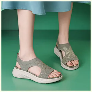 Close-up of olive green wedge sandals with sparkling rhinestones on flyknit fabric