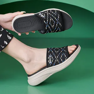 Women's black woven wedge sandals with colorful polka dots and lightweight platform sole