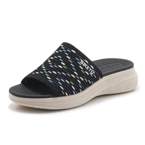 Women's wedge knit platform slides featuring a breathable black woven upper and thick sole
