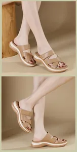 Detailed view of women's platform cross-strap sandals with brown leather finish on wooden base