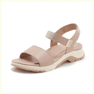 Detail view of pink sporty sandals featuring a thick platform sole and adjustable strap