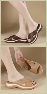 Close-up of platform wedge sandals with crisscross straps and decorative buckles