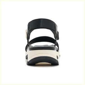 Rear view of chunky platform sandals with black fabric straps and gold metal buckles