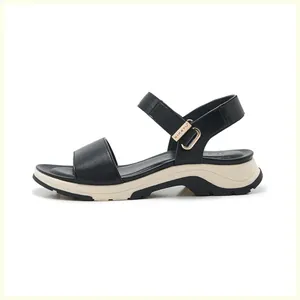 Detail of black sports sandal featuring thick platform sole and adjustable metal buckle