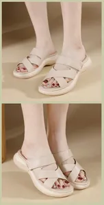 Macro detail of the beige platform slide sandal featuring soft cross straps and wedge sole