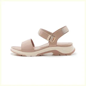 Detailed side view of pink platform sandals with velcro straps and non-slip rubber soles