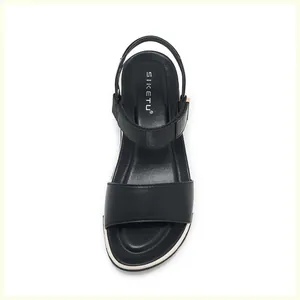 Close-up of black platform sandal featuring SIKETU brand logo and soft leather texture