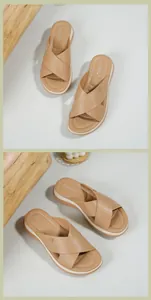 Close-up of khaki platform sandals with crisscross straps and textured wedge sole