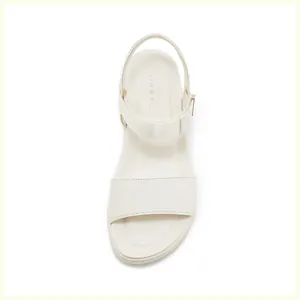 Top-down view of cream platform sandals featuring a soft padded insole and adjustable buckle