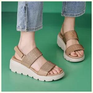 Detailed view of beige wedge sandals with rhinestone straps and velcro heel strap