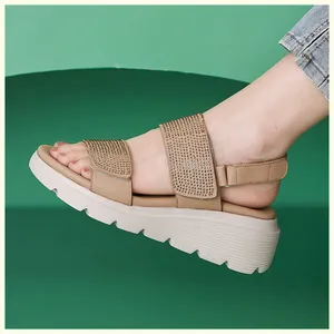 Detail of wedge sandals with rhinestone straps and adjustable velcro heel closure