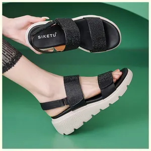 Close-up of women's wedge sandals with rhinestone-encrusted straps and non-slip sole