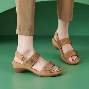 Detail of khaki wedge sandals featuring rhinestone bands and adjustable velcro strap